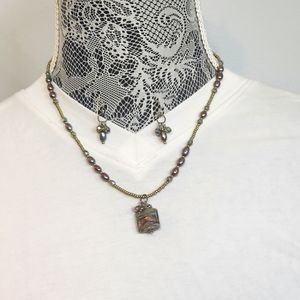 Artisian handmade beaded necklace with matching earrings.